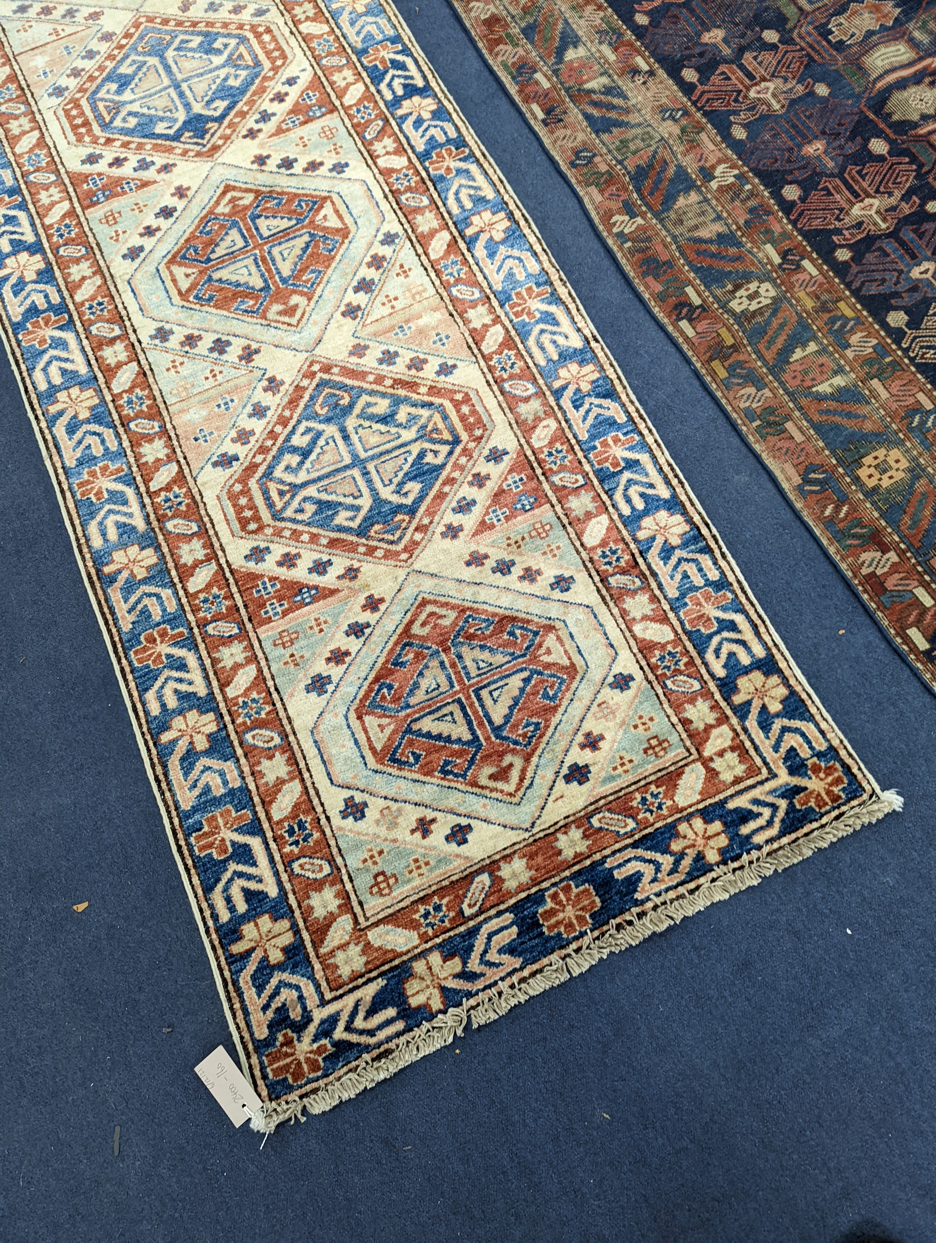 A Caucasian design ivory ground runner, 280 x 70cm